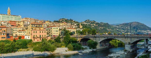 Colorful houses under blue sky in old town of Ventimiglia, Italy.