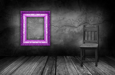 purple frame and wood chair in interior room with gray stone wal