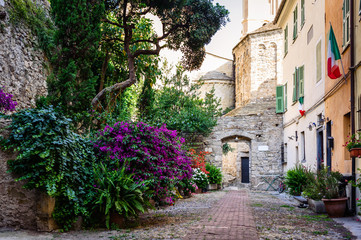 Obraz na płótnie Canvas The yard with many flowers in the ancient town of Ventimiglia. Italy.