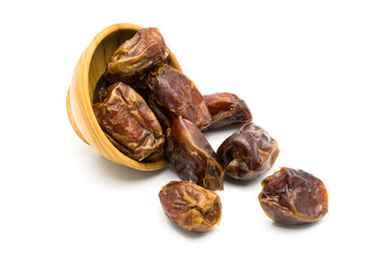 ied dates fruit and a wooden bowl