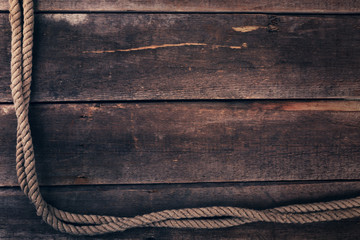 old ship rope on wooden plank background