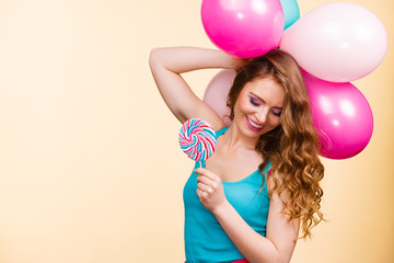 Woman with colorful balloons and lollipop