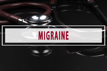 Obraz premium Stethoscope on black background with text MIGRAINE