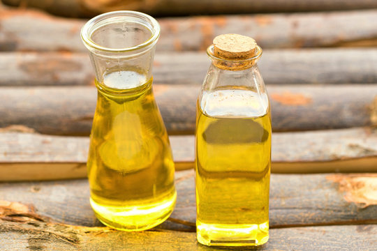 Olive oil in a bottle on wooden table.