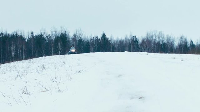 120 FPS SLO MO Snowboarder is being dragged by a snowmobile, winter fun extreme