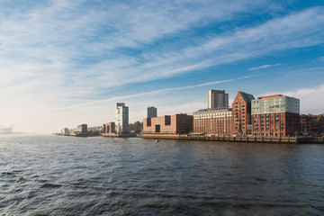 Fototapeta premium Hamburg, Germany - November 01, 2015: Scenic view from the river Elbe towards the open sea with fascinating fascades right hand