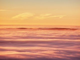 Obraz premium In winter mountains. Peaks of mountains above creamy mist.