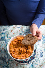 Eating hummus on the patterns background vertical