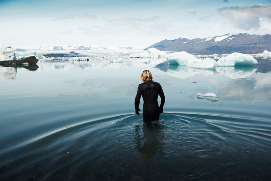 Man in wetsuit, stood in cold water, Iceland, Europe 