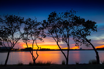 Sunset with colorful sky reflection on water and rock 