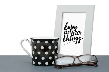 Enjoy the little things. Handwritten inscription in the frame. A Cup of coffee
