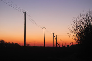 The silhouette of electricity pole at twilight