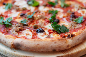 Pizza with meat and puttanesca sauce