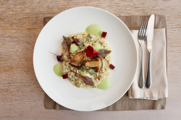 Risotto with fried porcini mushrooms on plate