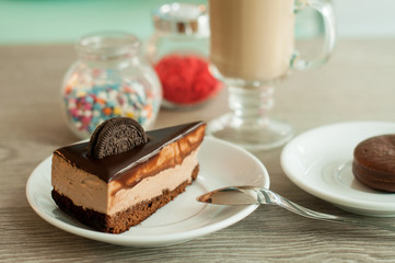 cake, chocolate cheesecake and cappuccino for breakfast. Wooden background, banner for confectionery