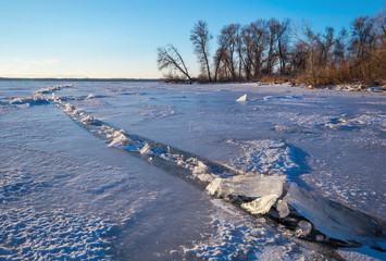 Winter landscape with frozen lake and trees. Composition of natu