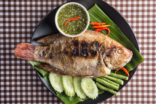 Grilled Fish and Thai Sauce on table.