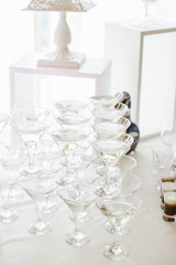 Glasses with martini make a pyramid on white table