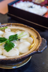 Traditional Shimabara Guzoni - soup with rice cake and seafood