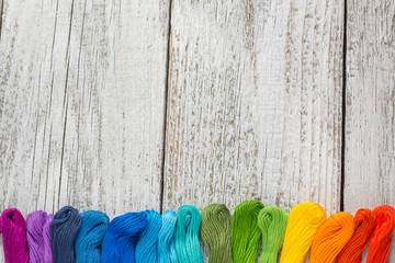 colorful sewing threads for embroidery on white background