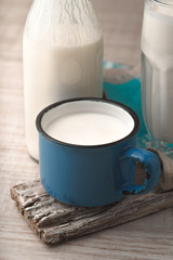 Glass, cup, bottle with kefir on a old stand