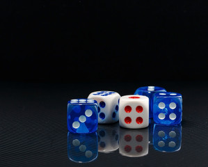 blue and white dices on the glossy black background