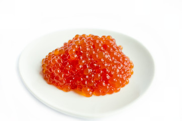 Red caviar on a platte, isolated on white background, close up