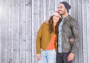 Couple standing against wooden background