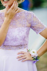 Violet bracelet corsage on bridesmaids' wirst