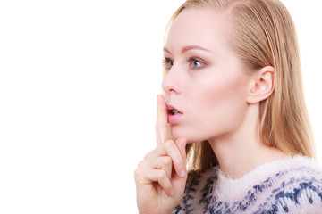 Young blonde woman making silence gesture