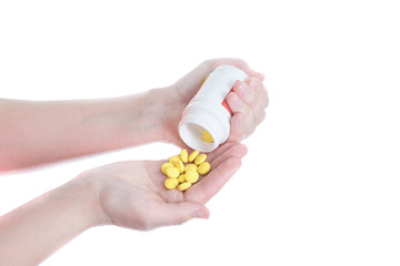 Yellow pills in hand