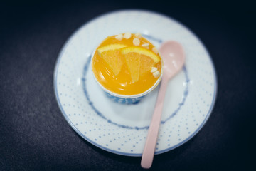 Orange cupcakes in blue baking cup and on the white dish, select focus.