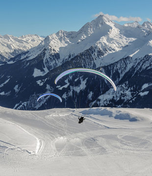 The pilot begins flight on a paraplane with a mountain-skiing slope of Penken - Mayrhofen, Austria?