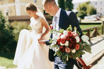 Gorgeous wedding bouquet made of red and white spearworts held b