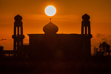 A silhouette of a mosque at sunrise vivid color , Thailand