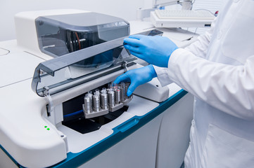 Close up scientist doing chemical test in modern laboratory. Selective focus