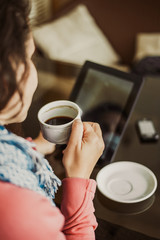 A girl sits in cafe and working on my laptop online