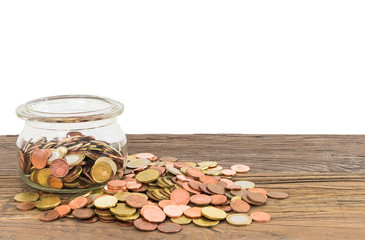 Money savings concept: Glass jar with European money coins.