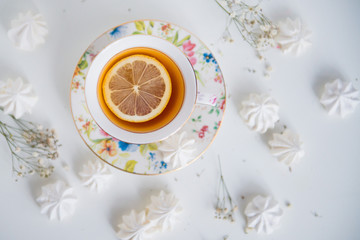 Obraz na płótnie Canvas чашка чая с лимоном и безе. Взгляд сверху