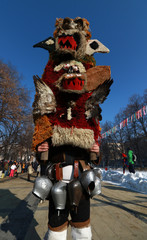 Fototapeta na wymiar Pernik, Bulgaria - January 28, 2017: Masquerade festival Surva in Pernik, Bulgaria. People with mask called Kukeri dance and perform to scare the evil spirits.
