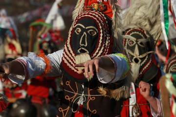 Obraz premium Pernik, Bulgaria - January 28, 2017: Masquerade festival Surva in Pernik, Bulgaria. People with mask called Kukeri dance and perform to scare the evil spirits.