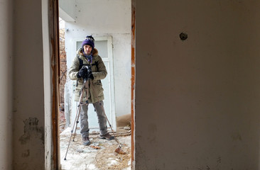 Photographer shooting in a ruined abandoned apartment