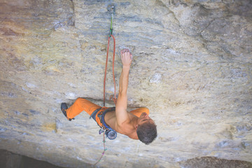 Climber climbs the rock.