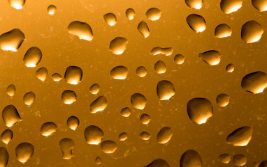 Water drops on the glass at sunset