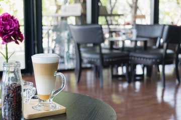Glass of Coffee late on the wood table in coffee shop.