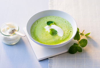 Pea soup and creme fraiche in a bowl