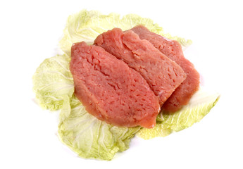 Raw sliced meat on a cabbage leaf