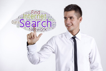 Search on the Internet - Young businessman touching word cloud