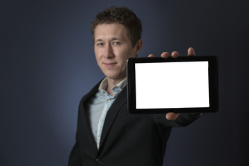 business man in suit standing, he showing tablet. Defocused model