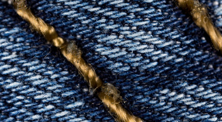 thread on jeans as a background. macro